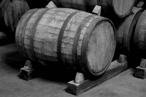 istock Wine barrels stacked in the old cellar. 1297505372