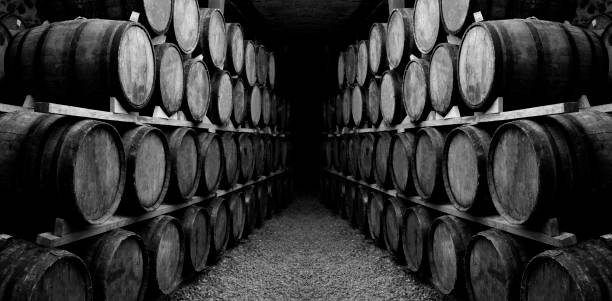 istock Wine barrels stacked in the old cellar. 1297505401
