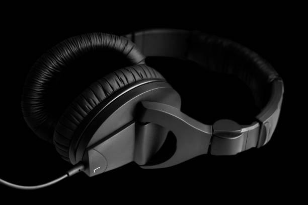 istock headphones, for music on black background 1297507578