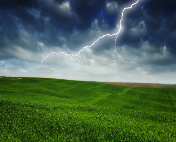 istock lightning over a hilly field. landscape with dramatic thunderclouds in the background 1297508020