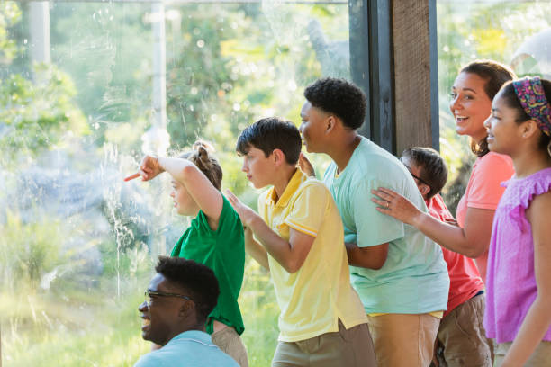 istock Summer field trip to zoo, including children with downs 1297509100