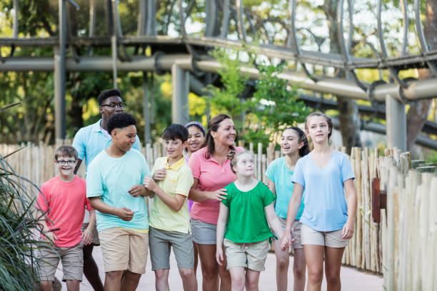 istock Summer field trip to zoo, including children with downs 1297509102