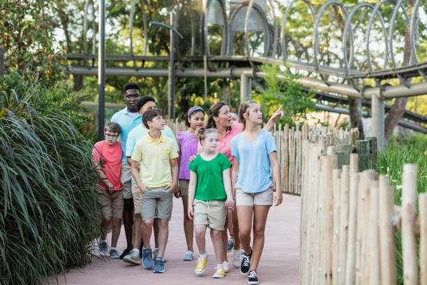 istock Summer field trip to zoo, including children with downs 1297509209