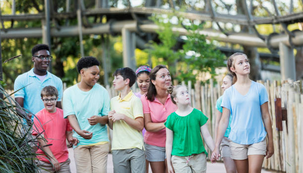 istock Summer field trip to zoo, including children with downs 1297509226
