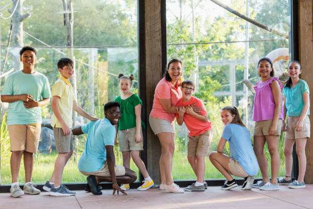 istock Summer field trip to zoo, including children with downs 1297509230