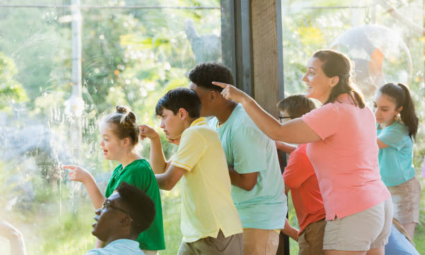 istock Summer field trip to zoo, including children with downs 1297509236