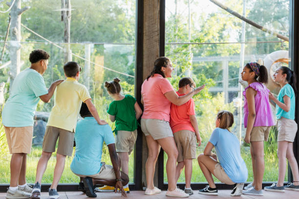 istock Summer field trip to zoo, including children with downs 1297509281