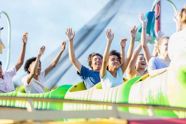 istock Teenagers having fun riding a rollercoaster 1297509337