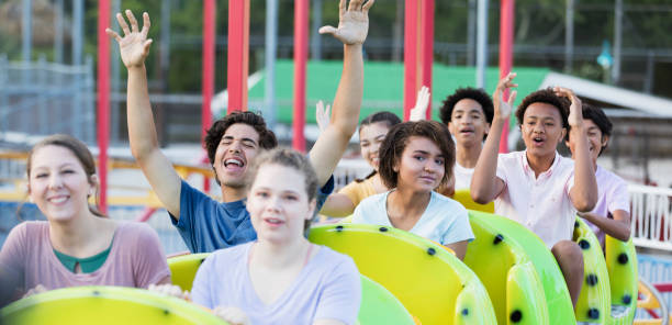 istock Teenagers having fun riding a rollercoaster 1297509349