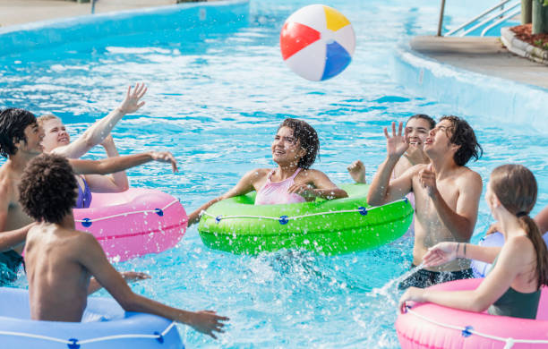istock Teenagers at water park playing in lazy river 1297509405