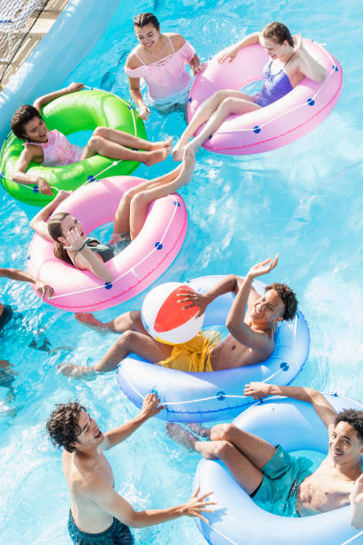 istock Teenagers at water park playing in lazy river 1297509532