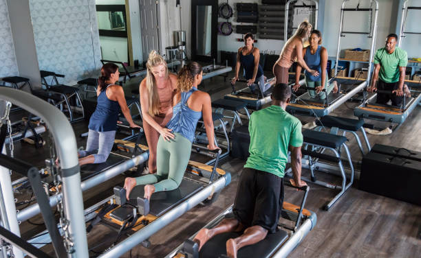 istock Three adults in Pilates studio with fitness instructor 1297509585