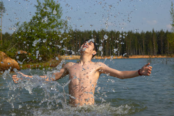 istock cute boy happily bathes in the water 1297510361