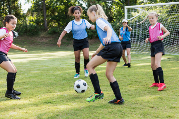istock Girl's soccer team practicing, playing scrimmage 1297510384