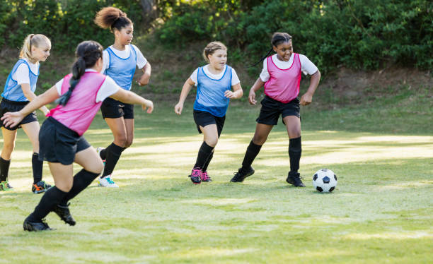 istock Girl's soccer team practicing, playing scrimmage 1297510405