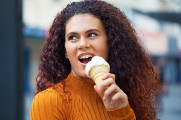 istock Beautiful woman eating ice-cream 1297515319
