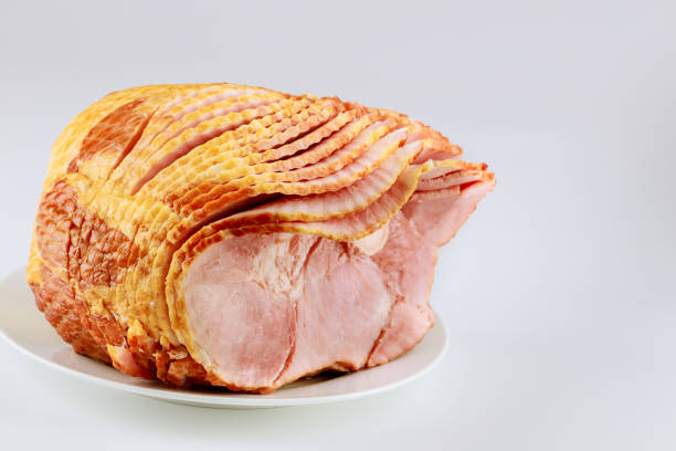 istock Spiral sliced pork ham isolated on white background. 1297517756
