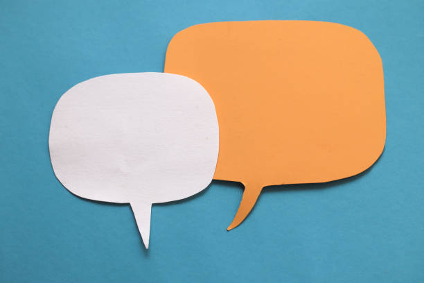 istock Two empty blank color paper speech bubble balloon dialog for your design, flat lay top view 1297519795