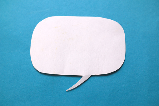Empty blank color paper speech bubble balloon dialog for your design, flat lay top view concept