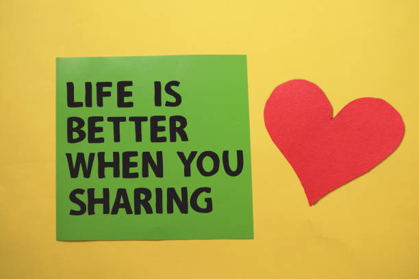 istock Life is better when you sharing, text words typography written on paper against yellow background, life and business motivational inspirational 1297519875