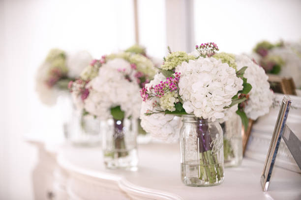 istock White hydrangea bridal bouquets in mason jars on white dresser with mirror 1297523037