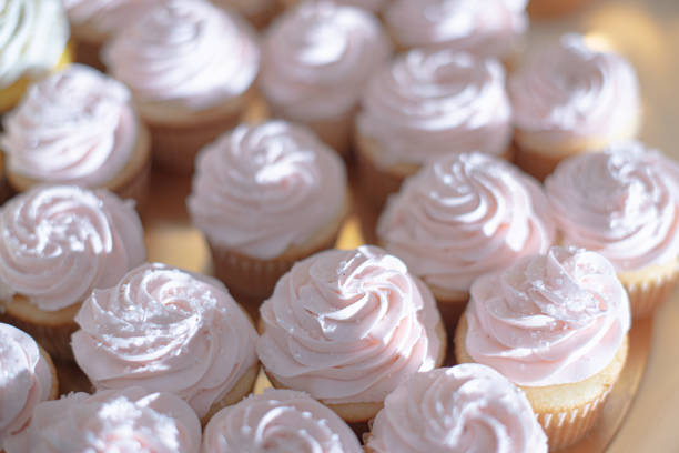 many cupcakes on shelf shelves in wedding party. dessert serving for wedding guest.