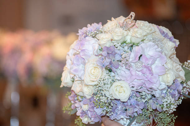 istock White roses and purple hydrangea bridal bouquet in hand 1297523900