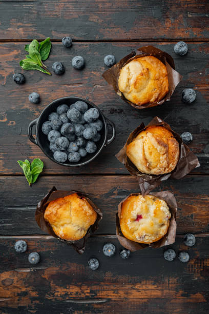 istock Muffin with blueberries, on old dark  wooden table background, top view flat lay 1297528975