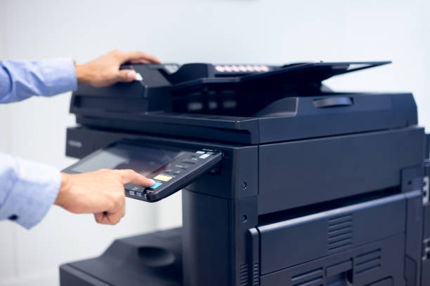 istock Bussiness man Hand press button on panel of printer, printer scanner laser in office. 1297529951