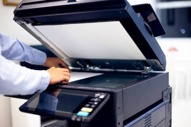 istock Bussiness man Hand press button on panel of printer, printer scanner laser in office. 1297529955