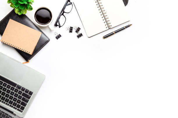istock Flat lay, top view office table desk. Workspace with, laptop,office supplies, pencil, green leaf, and coffee cup on white background. 1297529992