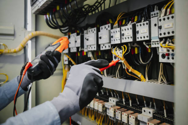 istock Electrical engineers test electrical installations and wiring on protective relays, measuring them with a multimeter. 1297529999