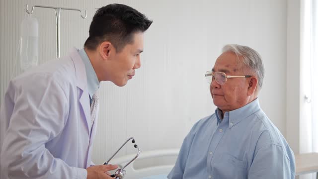Asian man doctor checking senior man patient at the hospital