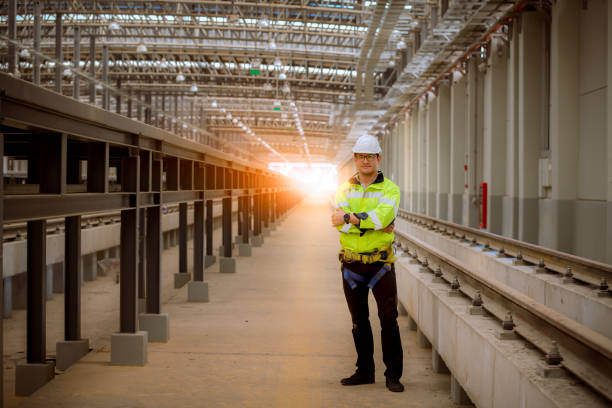 engineer railway under inspection and checking construction process train and railroad station .engineer wearing safety uniform and helmet by holding document in work. - switch yard imagens e fotografias de stock