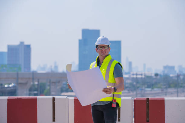 engineer railway under inspection and checking construction process train and railroad station .engineer wearing safety uniform and helmet by holding document in work. - switch yard imagens e fotografias de stock