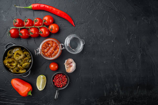 istock Tomato salsa or salsa roja - traditional mexican dip, on black background, top view flat lay  with copy space for text 1297532984