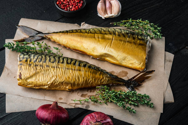 istock Smoked fish, on black wooden table background 1297533112