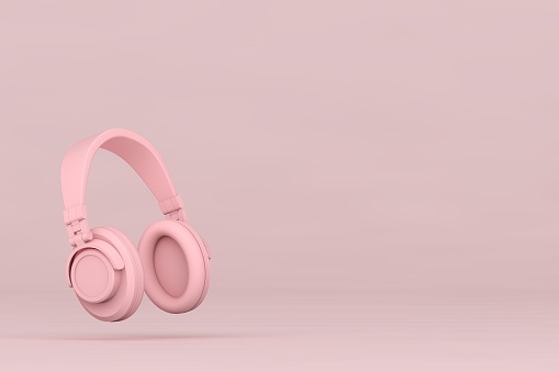 Pink headphone and empty product stand on pink background