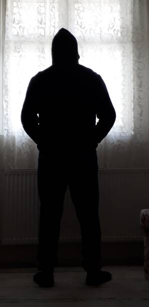 istock Hooded man Darkroom 1297539419