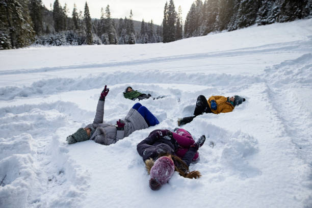 istock Family lying on the snow and looking at clouds 1297540596