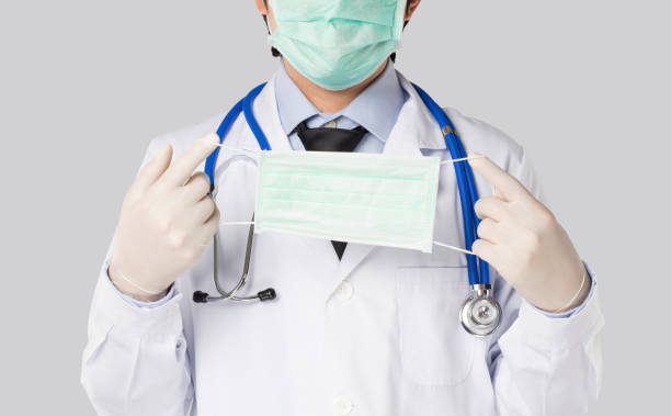 istock doctor held a mask to the front 1297541568