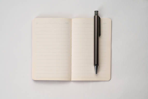 istock top view of white surface with notebook and pen 1297541587