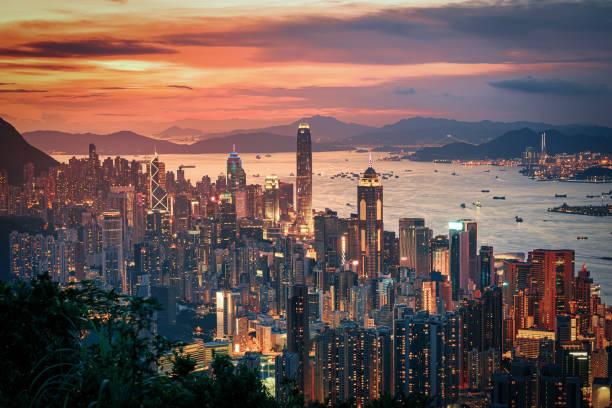 istock Hong Kong city on dramatic sky at sunset view from mountain. 1297541760