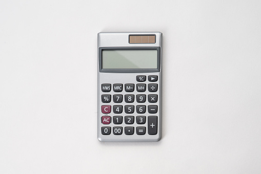 top view of white surface with calculator