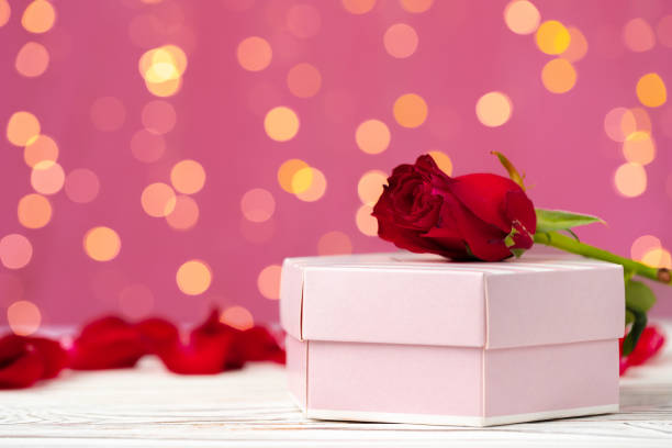 istock Valentines day gift and rose on wooden table 1297543456