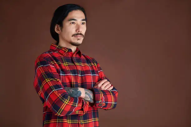 Photo of Young man portrait wearing a lumberjack shirt.