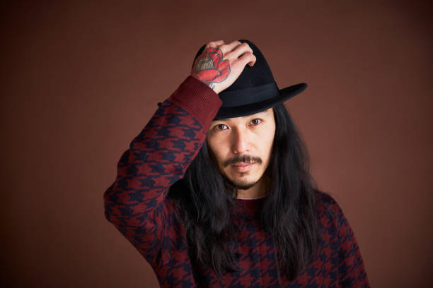 istock Young man portrait removing a hat. 1297546562