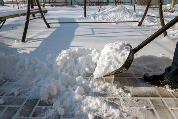 istock A man removes snow using a snow shovel. 1297547462