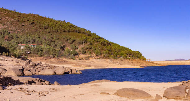 istock Mountain landscape with a lake, beach and a dam. 1297547954