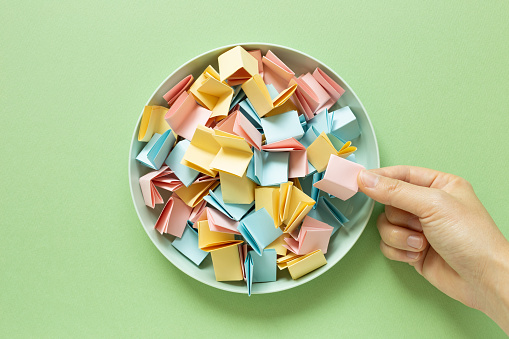 Draw lots. Folded colorful papers in bowl